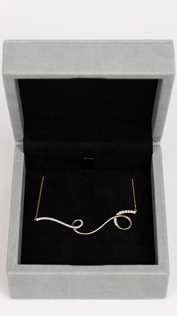 18k gold diamond Spiral necklace displayed in jewelry box