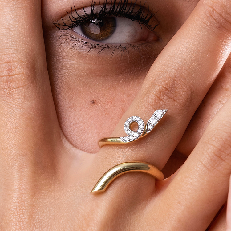 Spiral earring, worn by model, model covering face, only eye and jewelry shown